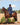 EQUIDRY women's long waterproof horse riding coat in navy/raspberry modelled by rider on horse showing storm skirts