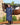 EQUIDRY women's long waterproof horse riding coat in navy/raspberry modelled by rider stood with horse