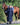 EQUIDRY women's long waterproof horse riding coat in navy/cream worn by rider walking with horse