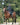 EQUIDRY women's long waterproof horse riding coat in black/turquoise modelled by rider hacking on horse