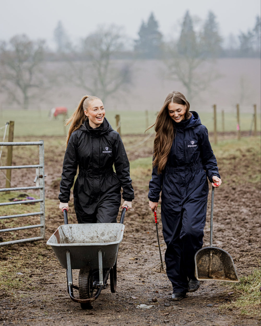 Two women wearing EQUIDRY All-In-Ones while working on the yard