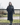 EQUIDRY women's thin fleece stowaway hood long waterproof horse riding coat in rich brown lifestyle