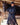 EQUIDRY women's long waterproof horse riding coat in Dark Navy/Navy modelled by rider stood on yard with horse