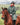 EQUIDRY women's long waterproof horse riding coat in black forest green/peacock pink shown by rider out hacking on horse