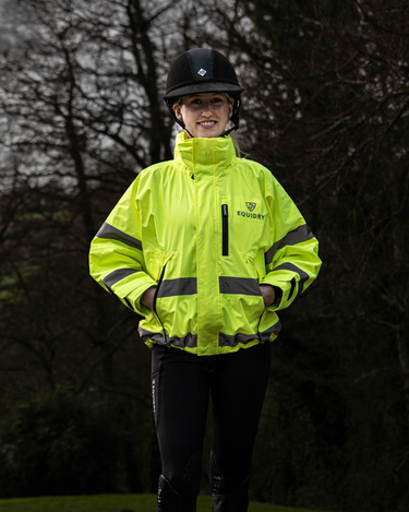 Person wearing an short EQUIDRY Hi Vis waterproof riding coat
