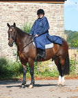 EQUIDRY women's long waterproof horse riding coat in navy/charcoal modelled by rider on horseback 