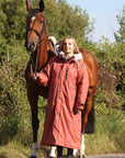 EQUIDRY Evolution Lux Women's Warm Waterproof Winter Horse Riding Coat Thick Fleece Lining with Faux Fur Trim Hood in chesnut, rider with horse 