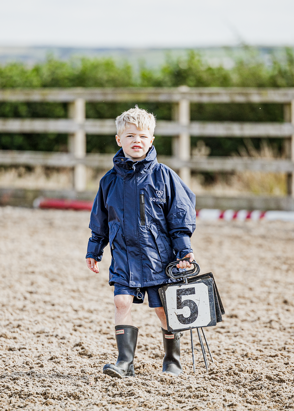 Shortie Child's Oversized Short Waterproof blouson style Riding Jacket Thin Fleece Lining Stowaway Hood in navy/navy kid in arena 