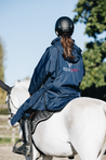 EQUIDRY Equestrian oversized waterproof Horse Riding Coat in Navy with Raspberry lining worn by Rider out hacking Pony