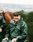 Black Forest Green EQUIDRY Equimac long waterproof raincoat worn by young horse rider and older man