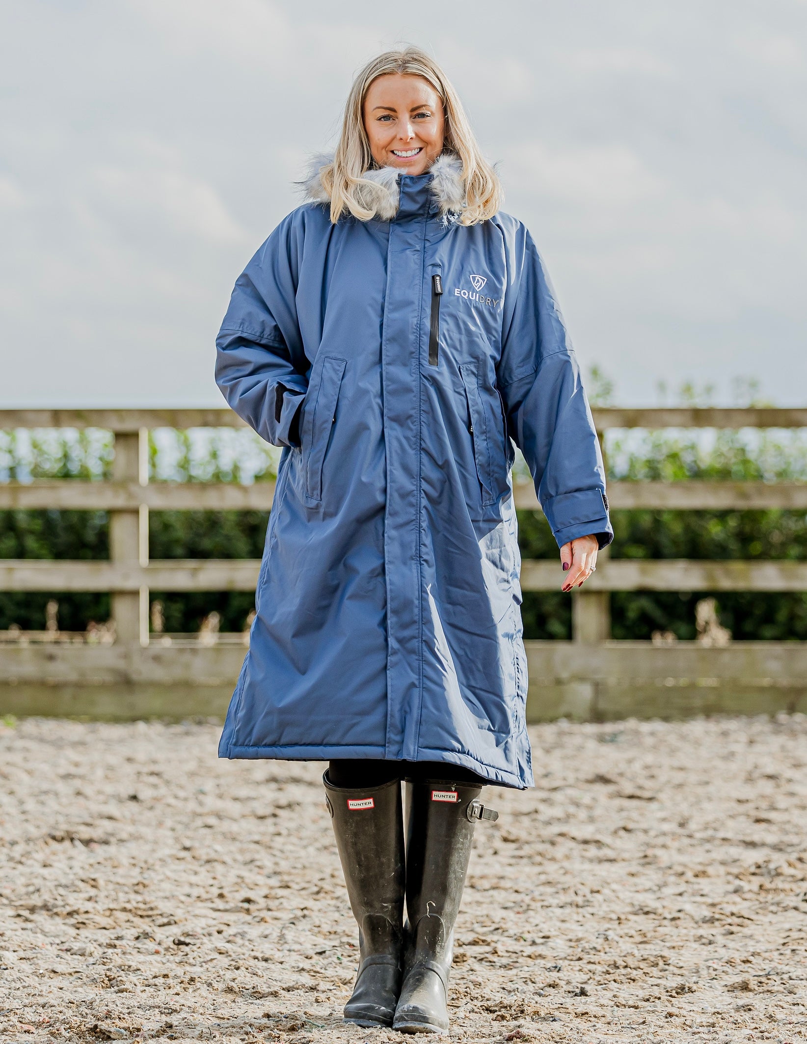 Evolution Lux Women's Warm Waterproof Winter Horse Riding Coat
Thick Fleece Lining with Faux Fur Trim Hood in steel blue rider in arena