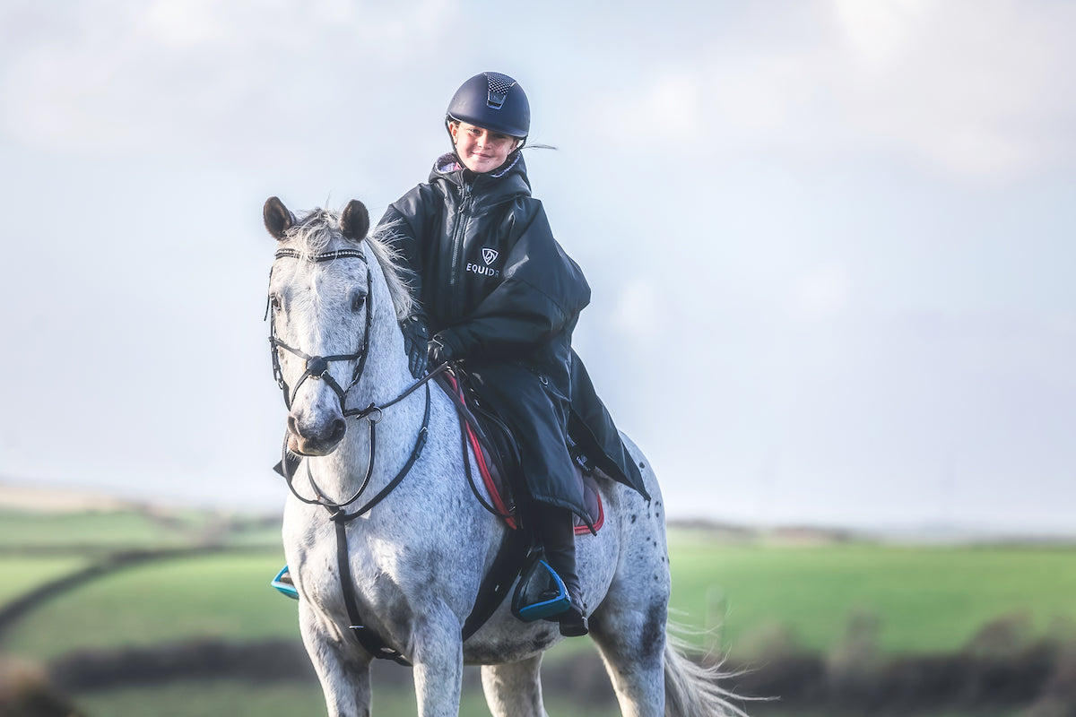 EQUIDRY Blackwith Grey lining oversized waterproof Horse Riding Coat, modelled by Pony Club Rider