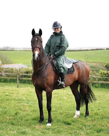 EQUIDRY waterproof horse riding raincoat thin fleece pro ride reflective black forest green rider on horse in field 