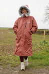 All Rounder Lux Chestnut EQUIDRY Equestrian oversized waterproof Horse Riding Coat with side zips modelled by a walker in the countryside