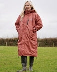 All Rounder Lux Chestnut EQUIDRY Equestrian oversized waterproof Horse Riding Coat with side zips modelled by a walker in the countryside