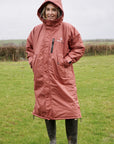 All Rounder Lux Chestnut EQUIDRY Equestrian oversized waterproof Horse Riding Coat with side zips modelled by a walker in the countryside