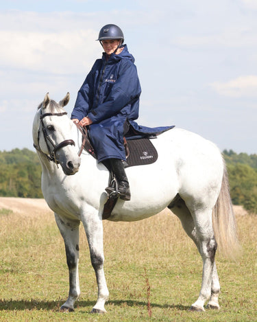 EQUIDRY waterproof horse riding raincoat All Rounder Original thick fleece Women's Navy/Pale Pink side view rider on horse