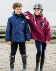 Shortie Child's Oversized Short Waterproof blouson style Riding Jacket Thin Fleece Lining Stowaway Hood in plum and navy in arena