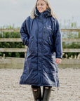 EQUIDRY Evolution Lux Women's Warm Waterproof Winter Horse Riding Coat Thick Fleece Lining with Faux Fur Trim Hood navy/cream front full view rider in arena 