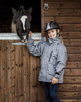 Shortie Child's Oversized Short Waterproof blouson style Riding Jacket Thin Fleece Lining Stowaway Hood in charcoal/penelope pink girl stood with horse 