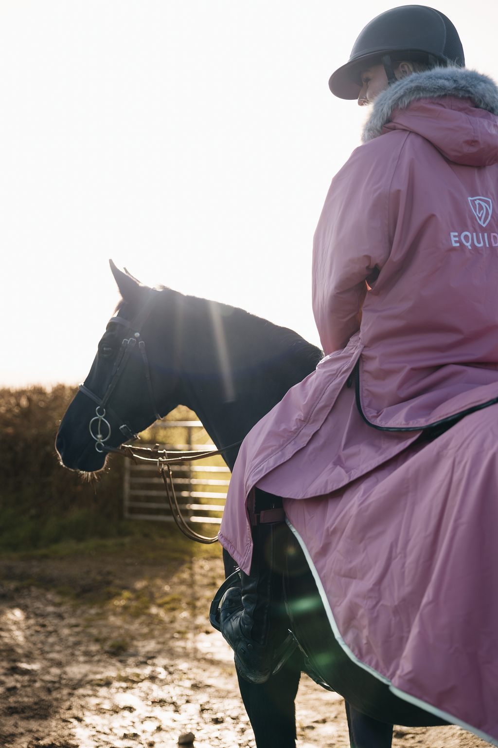 EQUIDRY Evolution Lux Women's Warm Waterproof Winter Horse Riding Coat Thick Fleece Lining with Faux Fur Trim Hood dusky pink on horse with matching exercise sheet