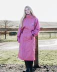 EQUIDRY Pink long lightweight waterproof horse riding coat worn by female adult 