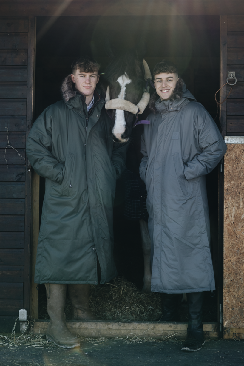 EQUIDRY Parka  with fur hood modelled by men on stable yard next to a horse