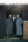 EQUIDRY Parka  with fur hood modelled by men on stable yard next to a horse