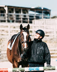 EQUIDRY men's waterproof short blouson style horse riding jacket in black with horse in arena 