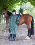 Black Forest Green EQUIDRY Equimac long waterproof raincoat worn by male rider stood with horse