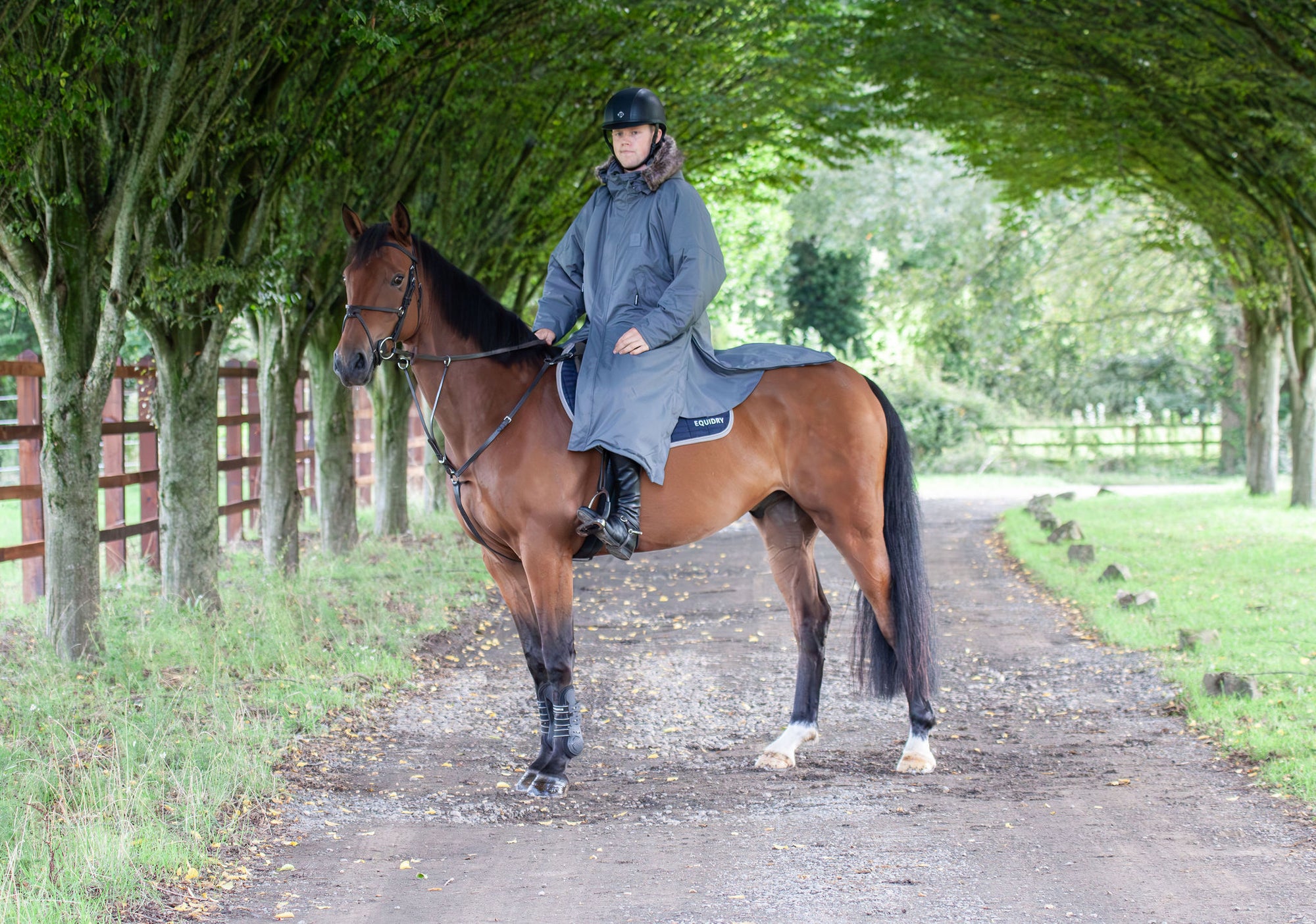 waterproof riding and leisure coat with padded inner detachable faux fur trim equidry in charcoal rider on horse 