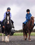 EQUIDRY women's long waterproof horse riding coat in Dark Navy/Cream group image of girls walking on horseback to have riding lesson 