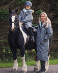 EQUIDRY women's long waterproof horse riding coat in Charcoal/Jade modelled by mother and daughter with horse 