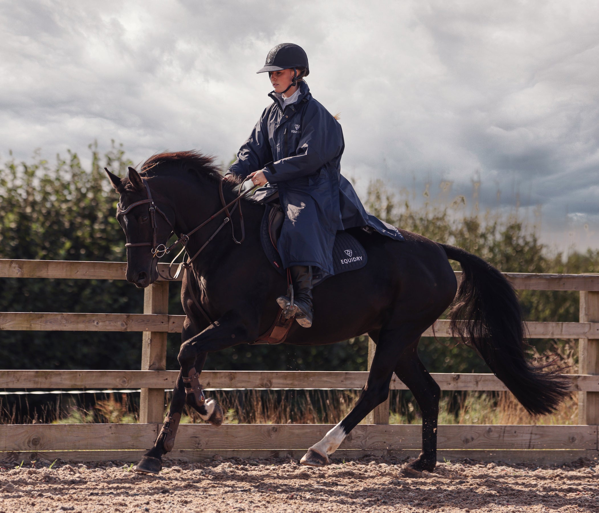EQUIDRY Pro Ride Evolution  Equestrian oversized waterproof Horse Riding Coat in Navy modelled by rider training  for competition