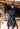 EQUIDRY women's long waterproof horse riding coat in Dark Navy/Navy modelled by rider stood on yard with horse