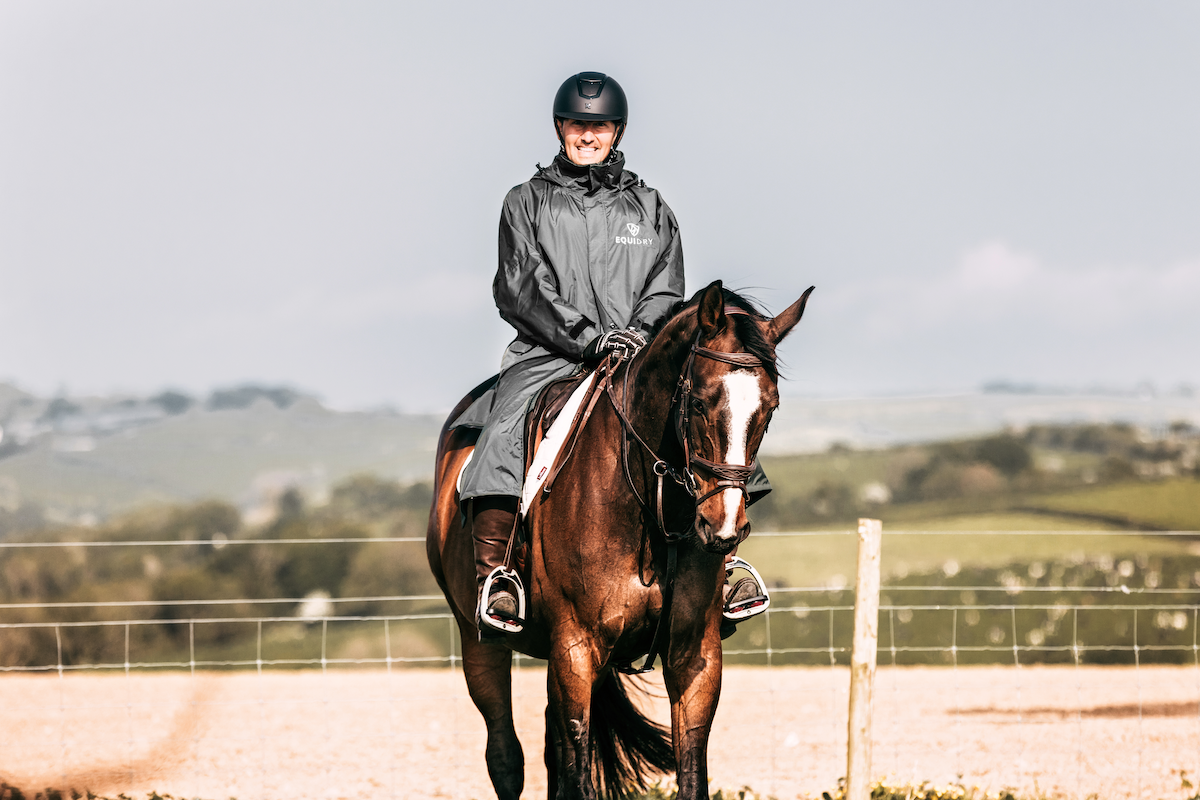 Charcoal/Grey EQUIDRY EQUIMAC LONG waterproof raincoat worn by male horse rider