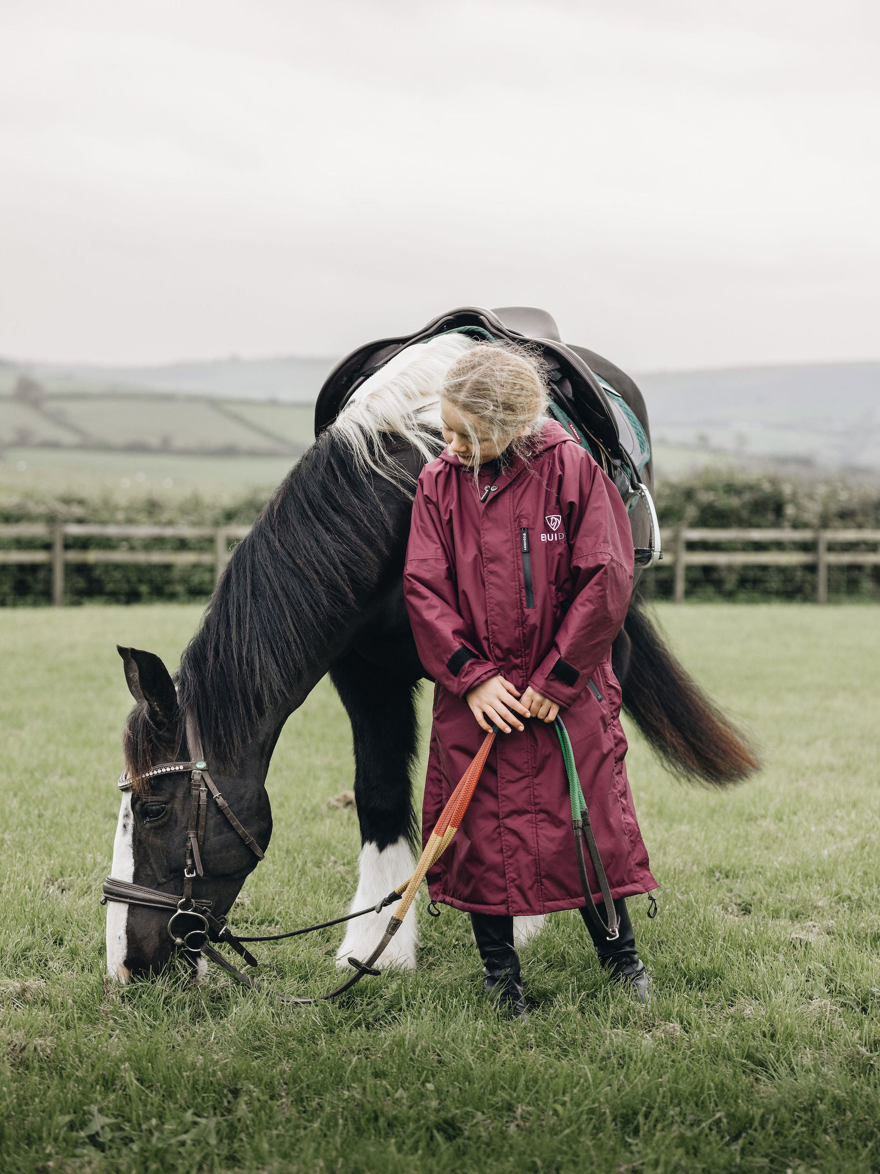 plum, EQUIDRY Equestrian oversized waterproof Horse Riding Coat  with side zips featured on Child with Pony  