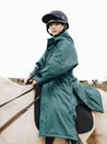 children/allrounder evolution lite/ Teal EQUIDRY Equestrian oversized waterproof  Coat with side zips modelled by child riding pony  